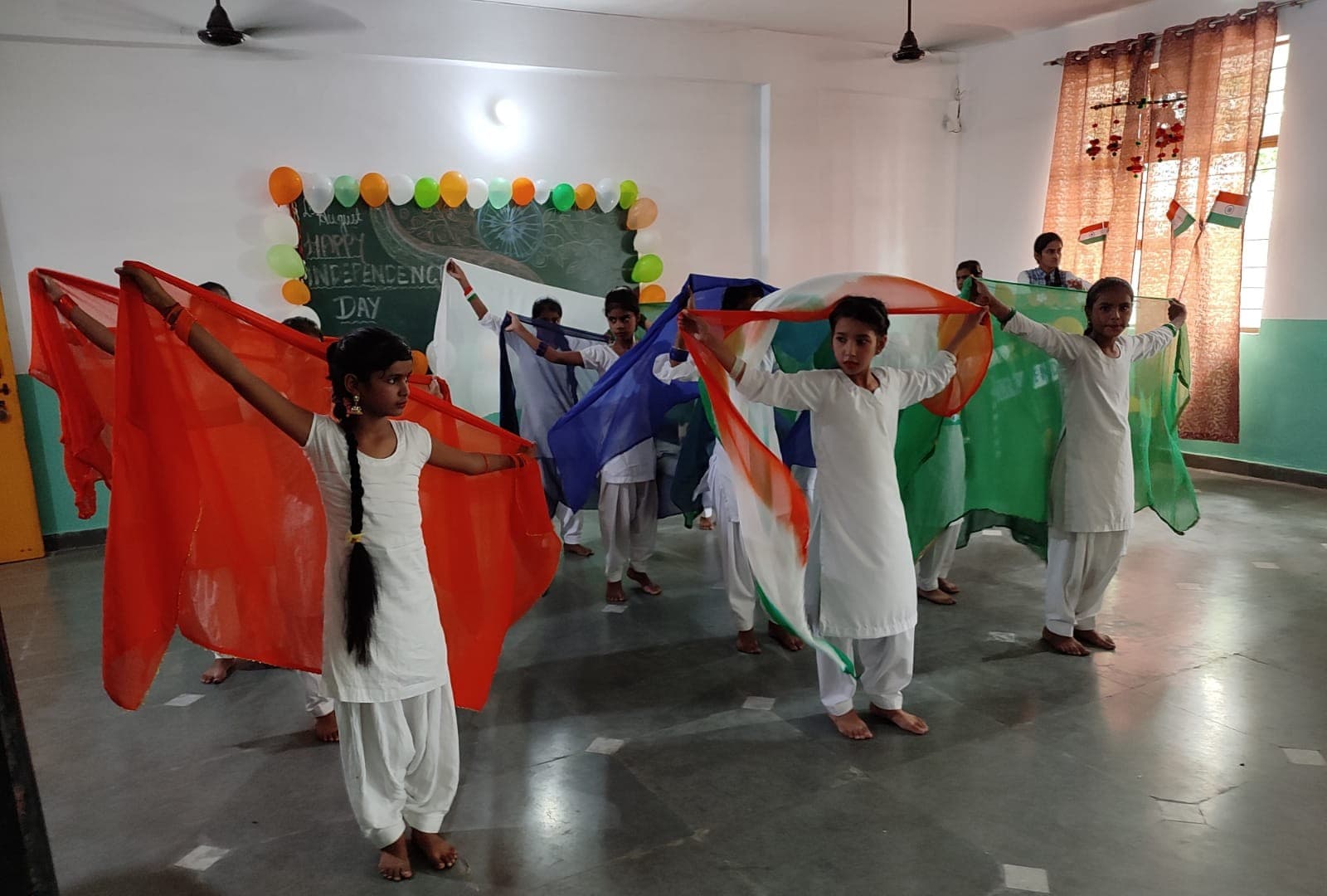 Students dancing with tricolour scarves on Independence Day